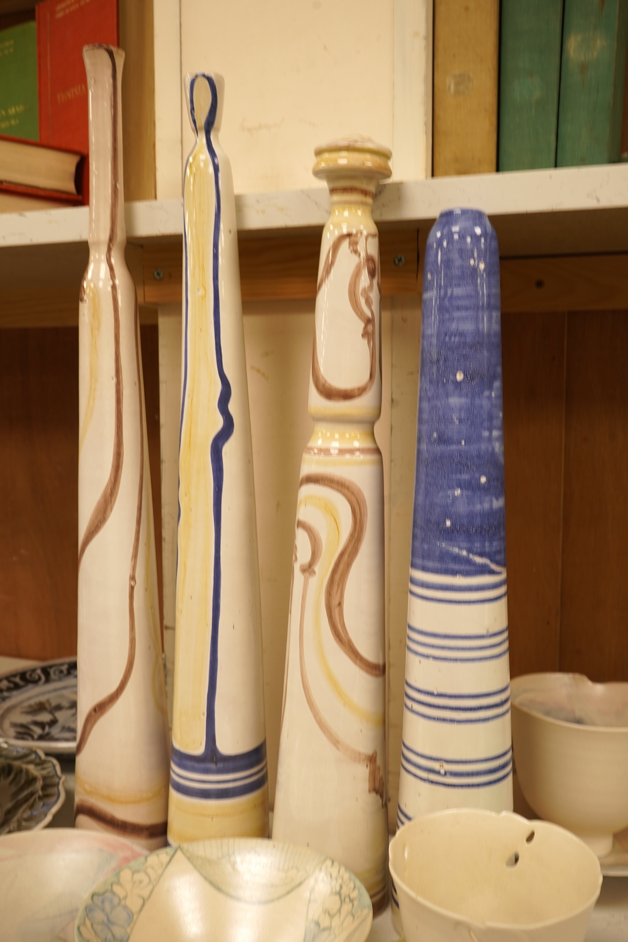 A mixed collection of European studio pottery to include a collection of four tall Italian candlesticks, tallest 58cm, two stoneware plates and a tureen and cover, etc.